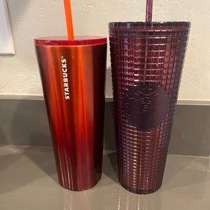 2 Starbucks cups with straws